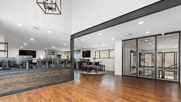 A spacious, modern kitchen with a central island, a dining area with a round table, and a large sliding glass door leading to a balcony. - Relaxing space with open living area (Kansas City)