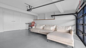 A modern living room with a sectional sofa, a small table, and a chair. - Panorama, Gerroa, South Coast (Gerroa)