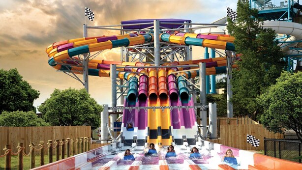 A water park with multiple water slides and a large circular structure.
