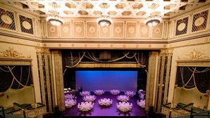 A theater with a stage, rows of green seats, and ornate ceiling decorations. - Steps from University of Dayton + Restaurant&Pool (dayton)