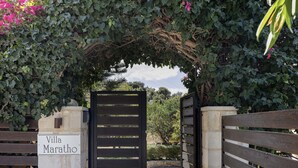 A gated entrance with a sign reading "Villa Maratho" and a wooden bench to the right. - Maratho Villa - With Private Pool (Rethymno)