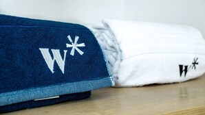 A blue and white towel with embroidered letters. - w Upscale Loft in the Heart of Bocagrande (Cartagena)