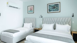 A hotel room with two beds, a large window, and artwork on the walls. - w Inviting Loft in the Heart of Bocagrande (Cartagena)