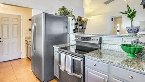A kitchen with a stainless steel refrigerator, an oven, a microwave, and a granite countertop. - Private Pool & Fenced Yard: Sunny Glendale Getaway (Glendale)