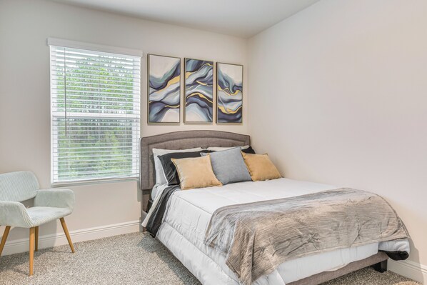 A bedroom with a bed, a chair, and a window with blinds. - 8 Mi to Dtwn Pensacola: Modern Escape w/ Patio! (Pensacola)