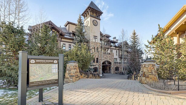 A historic building with a clock tower, stone walls, and a paved entrance area. - Ski-in/ski-out! Large Arrowhead Condo w/ Balcony (Edwards)