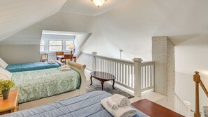 A bedroom with two beds, a desk, and a chair. There is a window with a view of the outside. - 3 Mi to Crab Tree Falls! Mtn-view Family Retreat (Montebello)