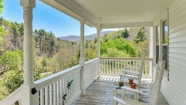 A covered porch with white railings, a wooden floor, and a view of a forested landscape. - 3 Mi to Crab Tree Falls! Mtn-view Family Retreat (Montebello)