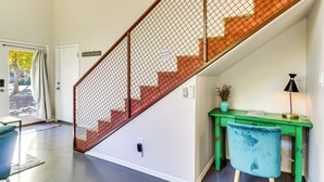 A staircase with a metal safety net, a green desk with a lamp, and a blue chair. - Stylish Home 2 Mi to Old Town Albuquerque! (Albuquerque)