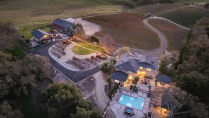 An aerial view of a residential property with a large house, a swimming pool, and a vineyard. - Private Paso Robles Wine Estate w/ Pool, Fire Pit & Vineyard Views (Templeton)
