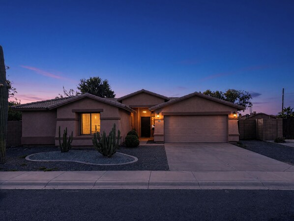 A residential house with a garage, a driveway, and a landscaped front yard with cacti. - Pet-Friendly 4BR Casa Grande Home | Private Pool (Casa Grande)