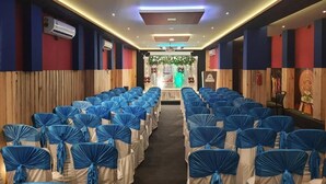 A hotel room with a bed, a nightstand, a dresser, and a window. - Emerald Royal Residency (Aluva)