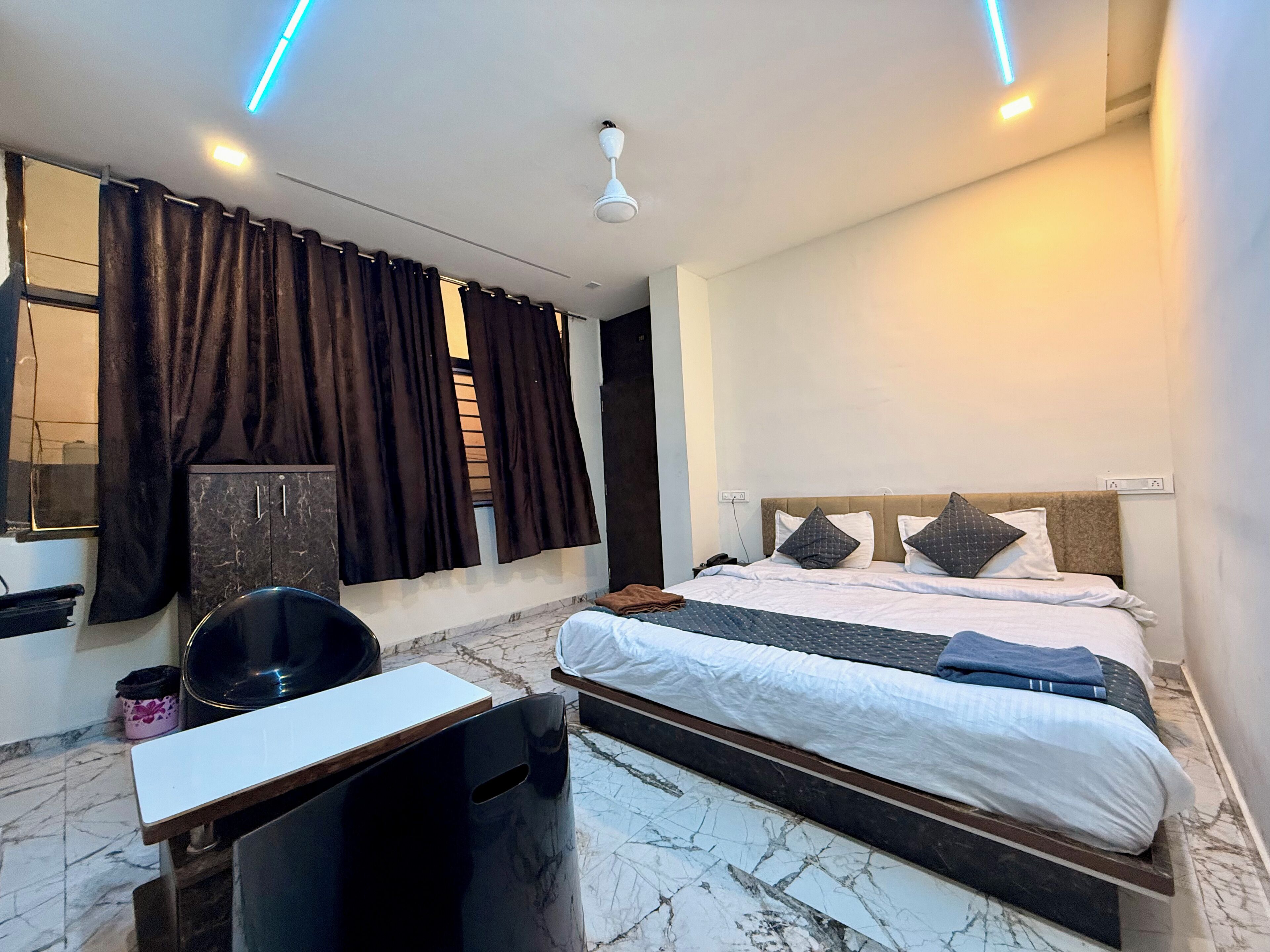 A modern bedroom with a bed, a desk, and a chair.