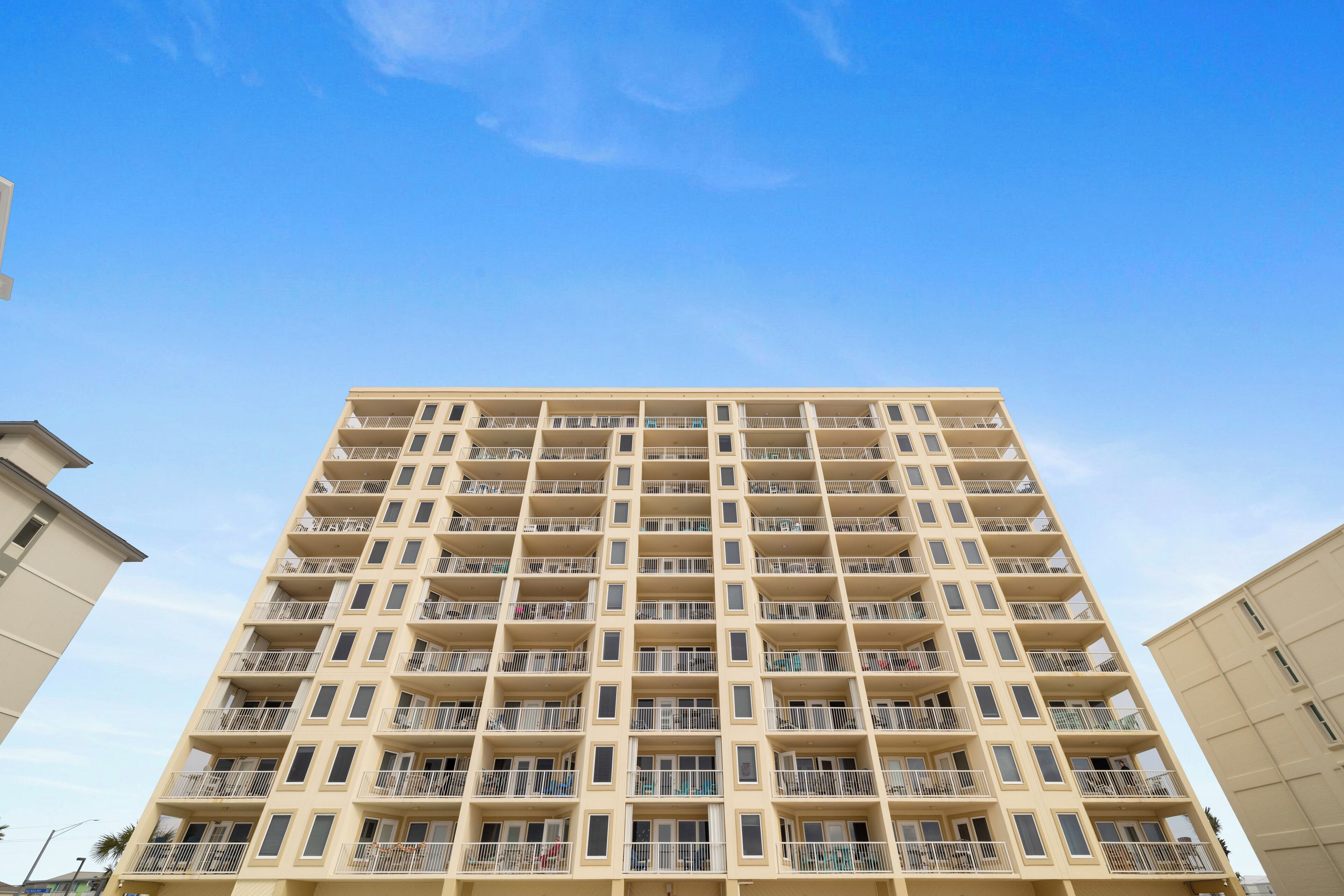 A high-rise building with multiple balconies and a uniform facade.