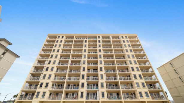 A high-rise building with multiple balconies and a uniform facade. - Boardwalk 886 by Liquid Life (Gulf Shores)