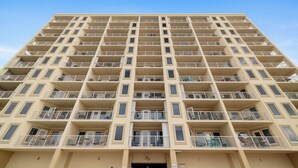A high-rise building with multiple balconies, a flat facade, and a clear sky. - Boardwalk 886 by Liquid Life (Gulf Shores)