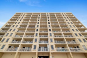 A high-rise building with multiple balconies, a flat facade, and a clear sky. - Boardwalk 886 by Liquid Life (Gulf Shores)
