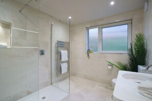A modern bathroom with a glass shower enclosure, a large window, and a sink with a mirror. - Fell View Residences , Lakes Escape by LetMeStay (Ambleside)