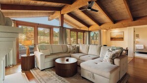 A spacious living room with a large sectional sofa, a round coffee table, and a ceiling fan. - A Sedona Scenic Escape w/ Private Wellness Center (Sedona)