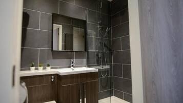Suite, City View | Bathroom | Shower, free toiletries, hair dryer, towels