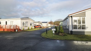 A residential street with mobile homes, a 'No Entry' sign, and a 'One Way' sign. - Beechtree Lodge 46 (Denny)