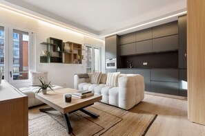 A modern living room with a sofa, a coffee table, and a bookshelf. - Genteel Home Concha Espina I (Madrid)