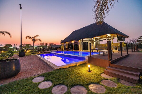 Outdoor pool, open 8:00 AM to 7:00 PM, pool umbrellas, sun loungers - Shumbalala Game Lodge Botswana (Gaborone)
