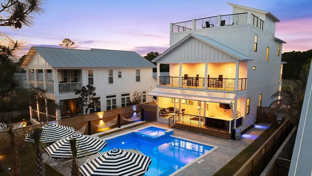 A two-story house with a swimming pool, outdoor seating, and a balcony. - The Gathering Place | Private Pool/Spa | Game Room | Rooftop Terrace (Santa Rosa Beach)