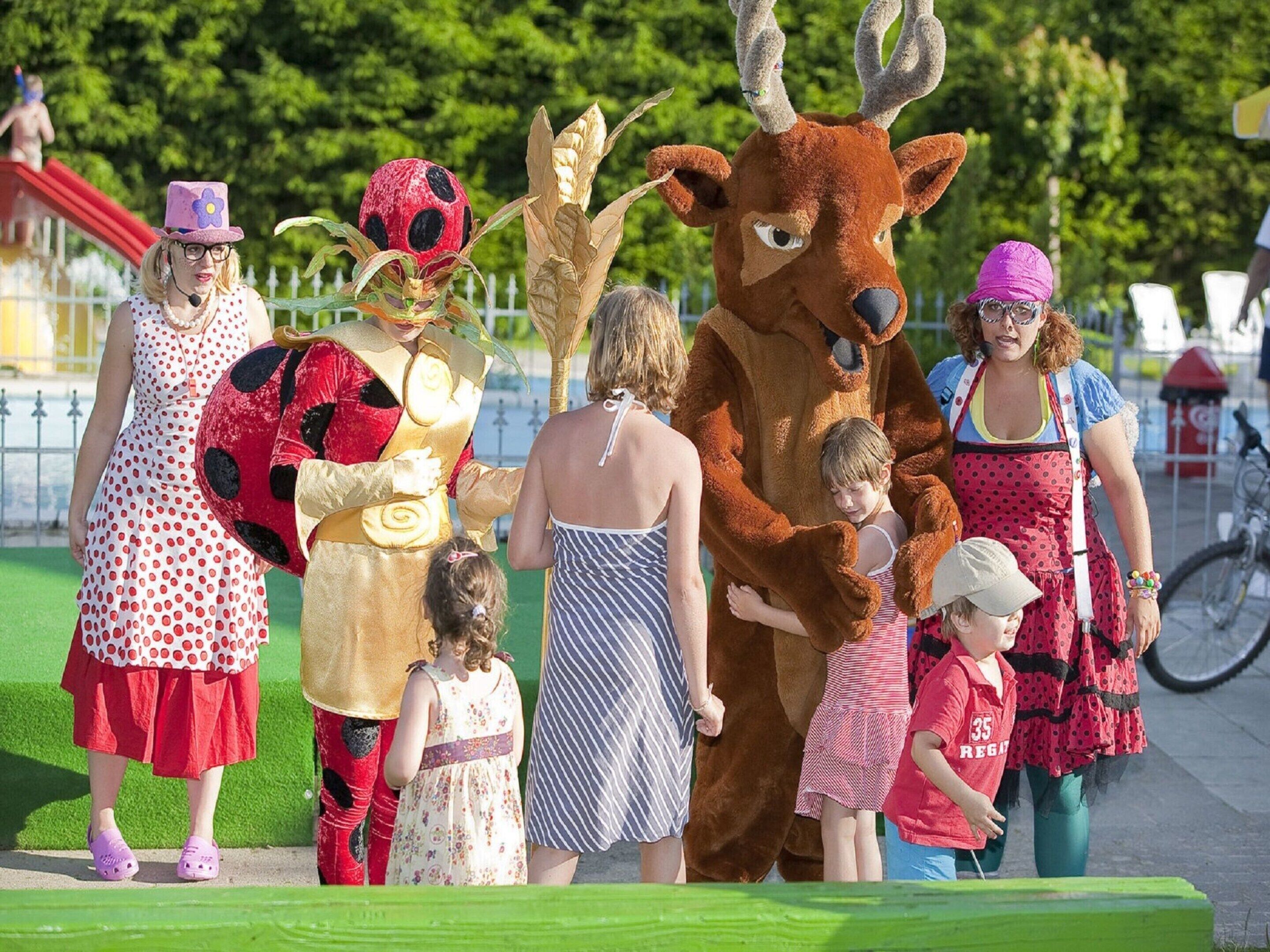 A group of people in costumes at an outdoor event.