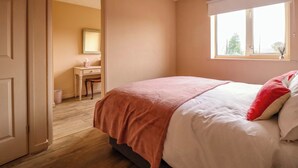 A bedroom with a bed, a window, and a door leading to another room. - 2 Horseshoe Road (Montgomery)