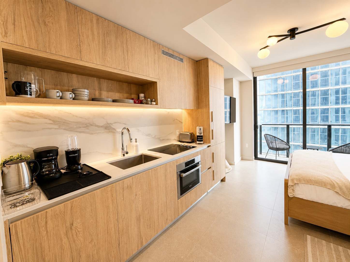 A modern kitchen with wooden cabinets, a marble countertop, and a built-in oven.