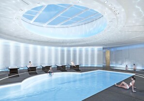 A modern indoor swimming pool with a skylight ceiling, lounge seating, and a large water feature. - Central Toronto 3BR suite w/Parking, Pool, Gym (Toronto)