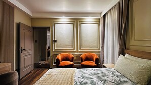 A hotel room with a large bed, two upholstered chairs, a wardrobe, and a mirror. - Spacious 2BR Home Near Patan with Himalayan Views (Lalitpur)