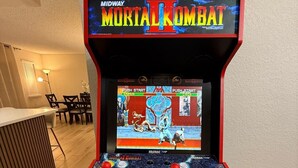 A Midway Mortal Kombat arcade machine with a screen displaying the game interface, joystick controls, and a coin slot. - Spacious 4-bedroom house with AC in charming Roseville (Roseville)