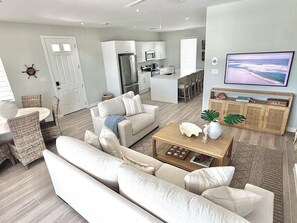 A modern living room with a sofa, coffee table, and a television. - Sun, Sand & Serenity Villa (Nassau)