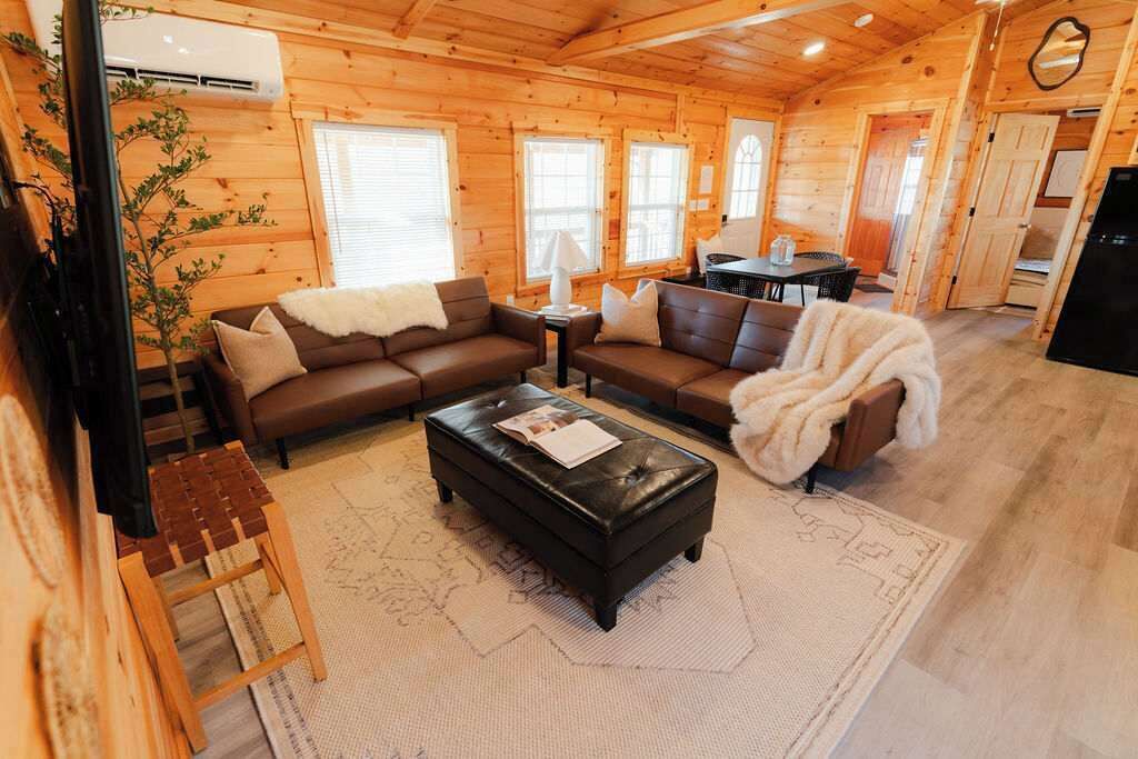 Living Room: Bright wooden walls embrace this inviting space, perfect for relaxation and fun!