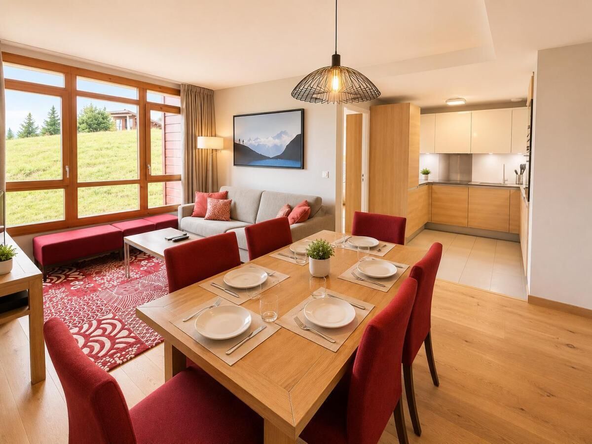 A modern living room with a dining area, large windows, and a view of the outdoors.