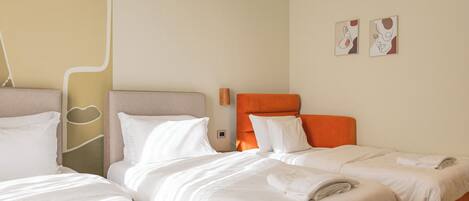 A hotel room with two beds, a large window, and a wall with abstract art.