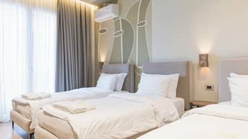 Deluxe Triple Room, Balcony, City View | Desk, laptop workspace, blackout drapes, soundproofing