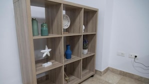 A wooden shelving unit with various decorative items. - Night In Sevilla Duplex (Seville)
