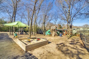 A playground with a slide, swings, and a climbing structure. - Families Welcome! Home w/ Playground in Kingston (Kingston)