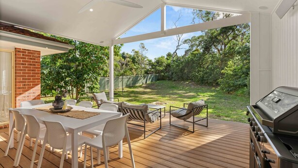 A covered outdoor patio with a dining table, chairs, and a grill. - 4 Bedrooms, Spacious Backyard, Fireplace, Walk to Beach (Callala Beach)