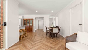 A spacious kitchen with wooden cabinets and a herringbone floor pattern. - 4 Bedrooms, Spacious Backyard, Fireplace, Walk to Beach (Callala Beach)
