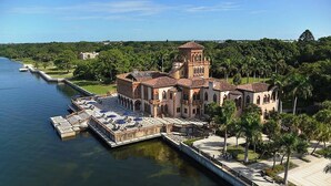 A large, historic building with a central tower, connected to a dock by a bridge. - Maison Bohème - Adults Only With Pool (Sarasota)
