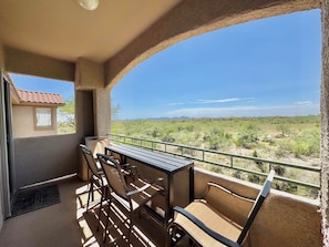 A balcony with a table and chairs, overlooking a desert landscape. - Tucson Mountain & Wildlife Views in Vistoso (Oro Valley)