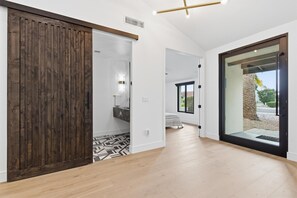 Luxury pivot door entry designed to feel like a five-star resort arrival