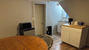 A compact kitchen with a microwave, a coffee maker, and a cabinet. - Cozy Private Studio w/ Kitchenette (Pittsburgh)