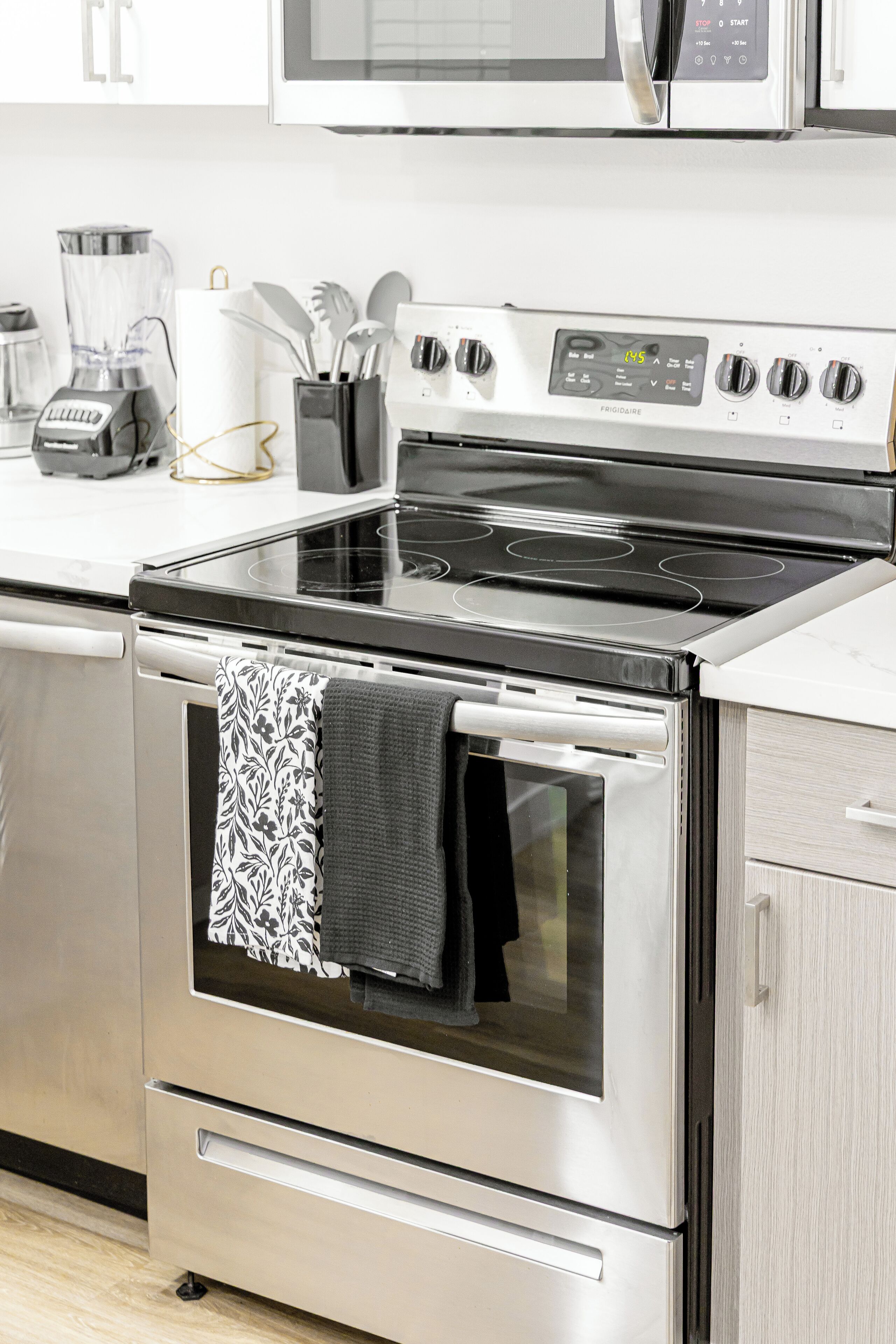A kitchen with a stainless steel stove, oven, and microwave.