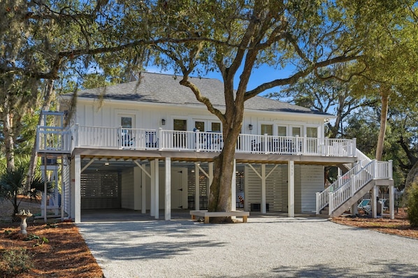 A two-story house with a covered driveway and a balcony.
