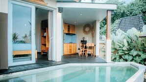 Una casa moderna con piscina, comedor y cocina.